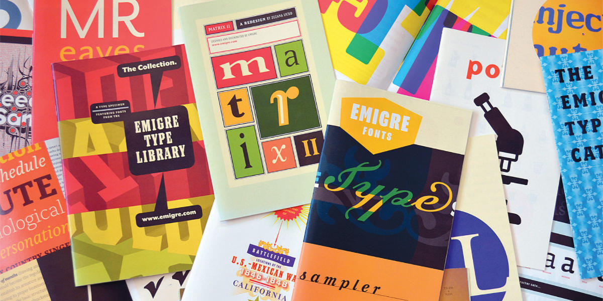 A disorganized pile of various brightly colored Emigre type specimen mailers. Some visible ones include Mr. Eaves, Keedy Sans, and Matrix II.